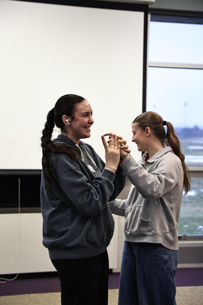 Creating their invention, juniors Madison Bono and Morgan Elliot participate in the class project. On Feb. 17, Theory of Knowledge had an International Baccalaureate Core Day in the project room.