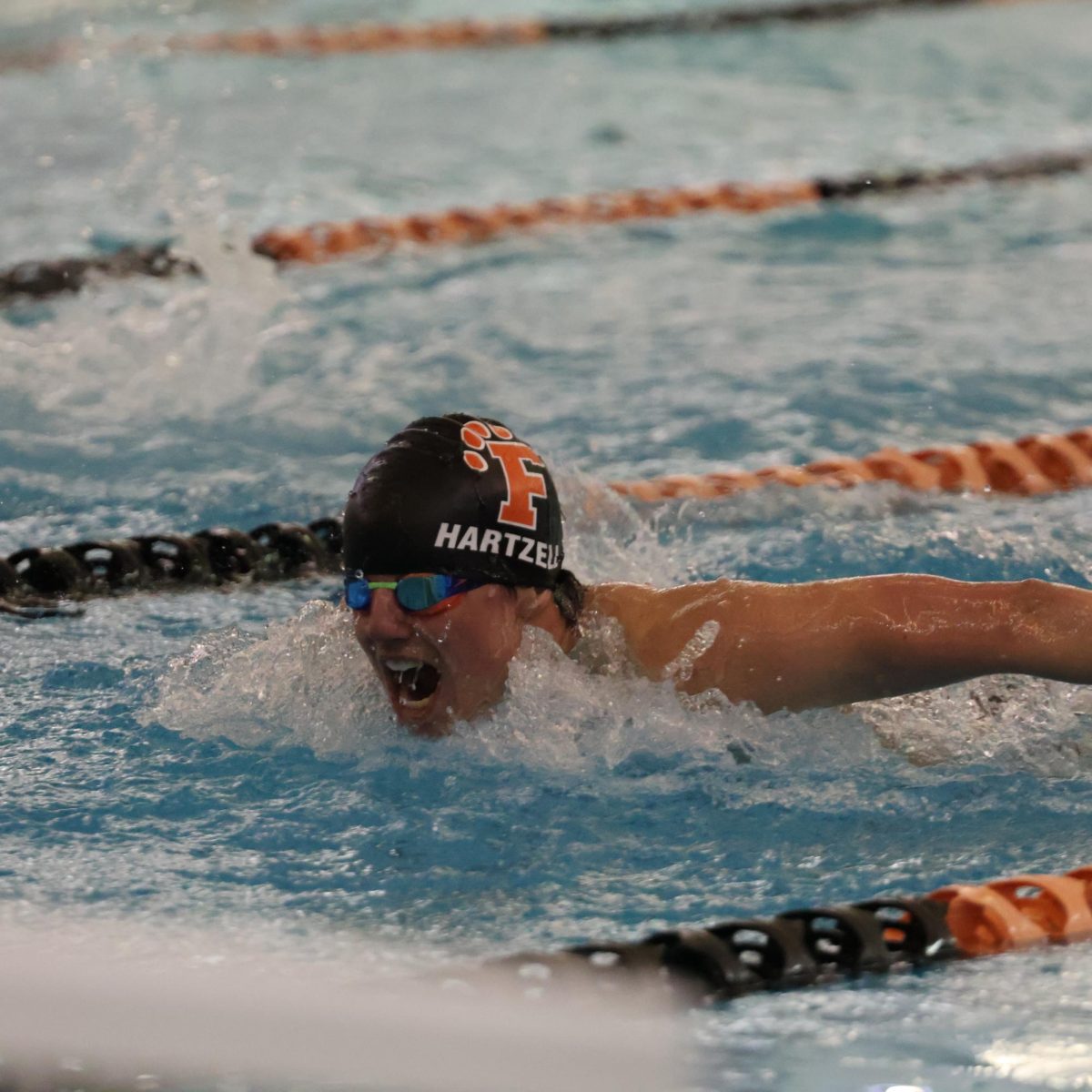 Butterflying, senior Nate Hartzell races at a meet. On Jan. 22, , the Fenton Varsity Boys Swim and Dive team had a meet against  Swartz Creek High School.