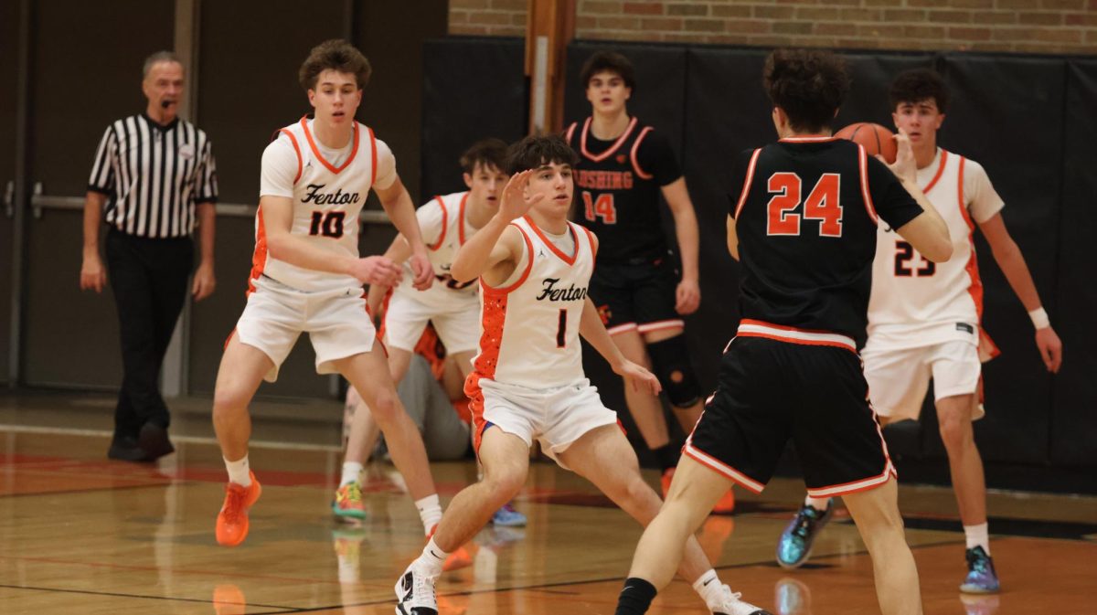 Open for the shot, junior Landry LaFontaine shoots the ball. On Feb. 13, Fenton Varsity boys' basketball went up against Flushing High School.