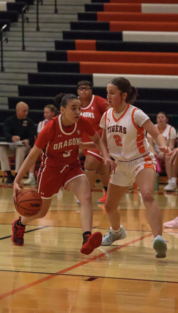 Guarding an opponent, junior Madison Eltringham plays in the game. On Jan. 23, girls varsity basketball competed against Swartz Creek and won 50-30. 
