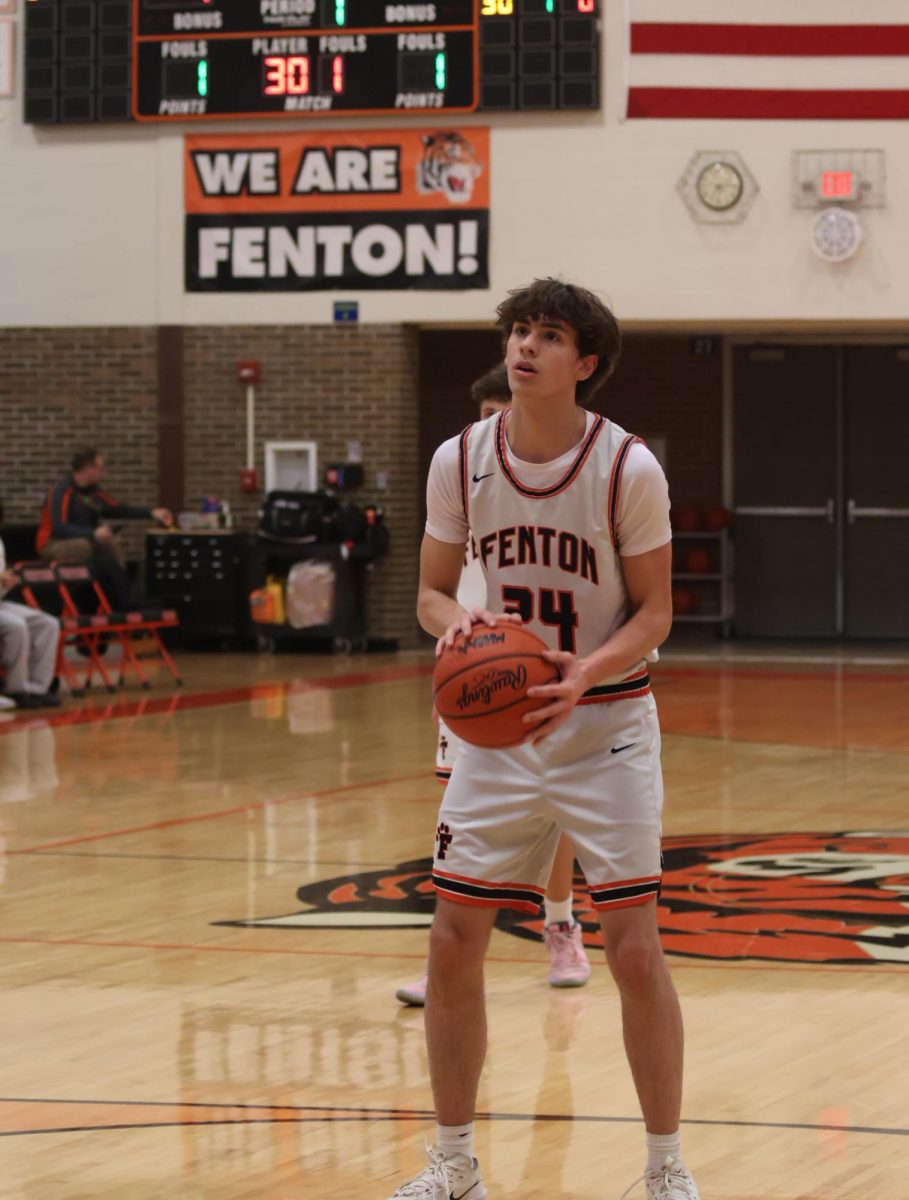 Setting up for a free throw, freshman Deton Thommen gets ready to shoot the ball. On Feb. 5, the JV Fenton high school team lost to Linden 42-0.