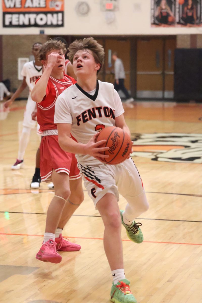 Looking at the net, freshman Leo MaCcaughan attempts to make a layup. On Feb. 5, the Fenton freshman basketball team played Linden and lost 29-57.

