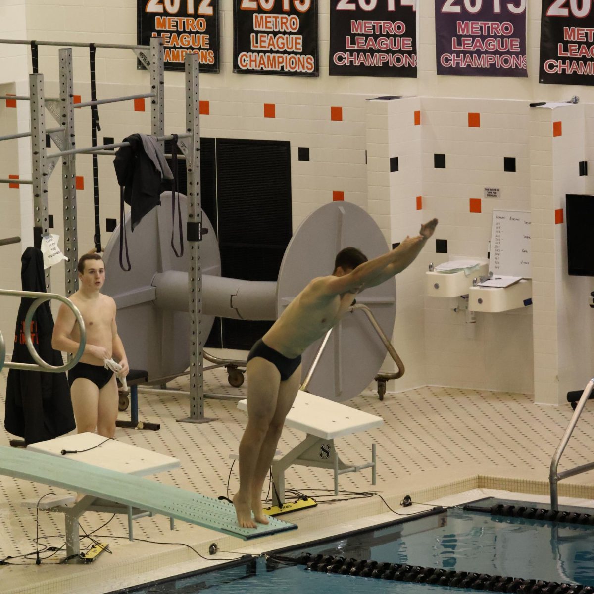 Diving, senior Adrian Habel competes in a swim and dive competition. On Jan. 8, the boys FHS swim team went up against Corunna high school.