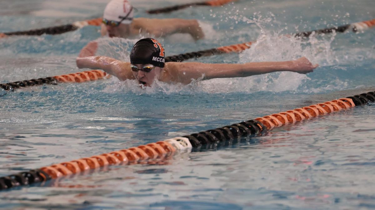Butterflying, sophomore Logan McCabe races at a meet. On Feb. 12, the Fenton Varsity Boys Swim and Dive team had a meet against Holly High School.