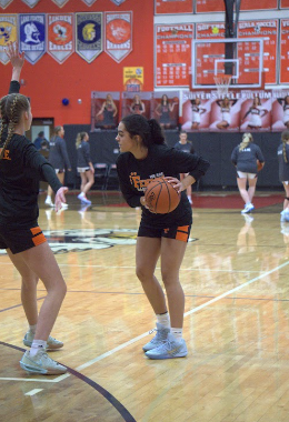 Warming up, sophomore Alejandra Ayotte gets ready to play for the Varsity girls basketball team. On Feb.6 Fenton girls' Varsity Basketball team takes on Linden and wins with a score of 37-30
