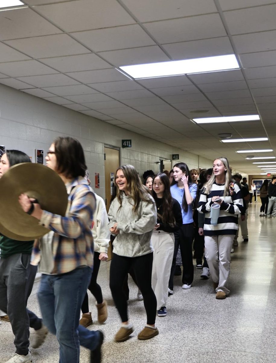 Celebrating their qualification, the DECA team walks out heading to their state competition. On March 5, the DECA team is state-bound.
