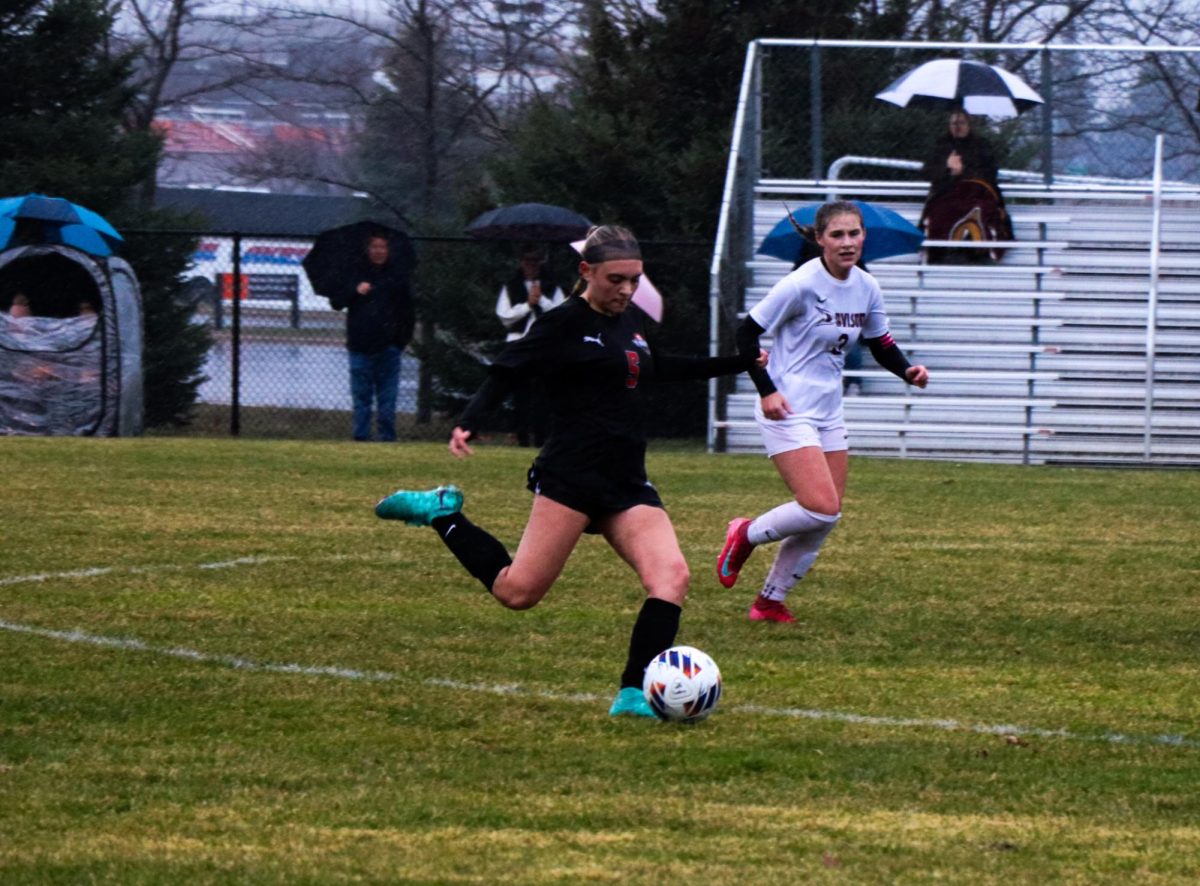 Kicking the ball, Freshman Aspen Burklow plays in an intense game with her team. On March 26, the girls Jv soccer team played in a division on loses 0-2. 
