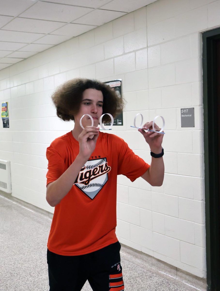Focusing on his throw, freshman Chuck Lipset is about to fly his bird. On March 27, biology classes did a bird lab seeing how far their tubes could fly.