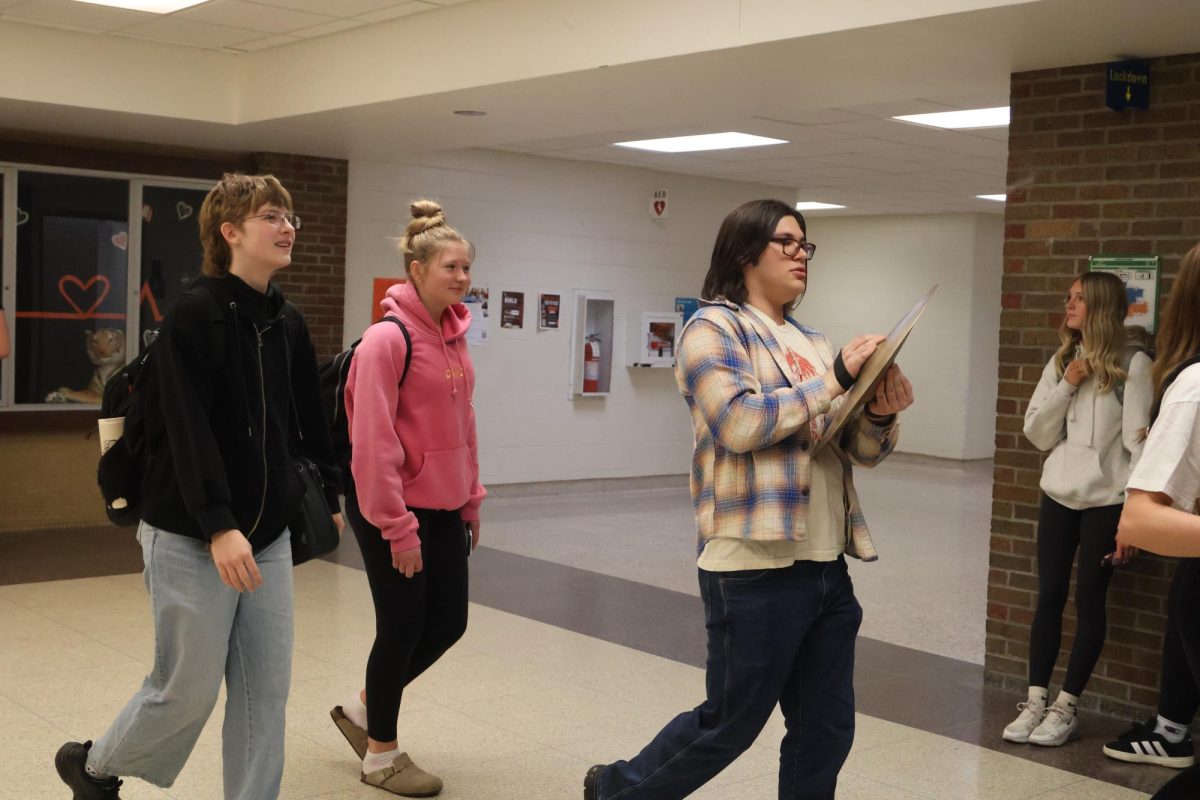 Walking down the hall, junior Madison Rush and sophomore Mia Salvia have a clap out for figure skating. On March 20, they head to the states for figure skating.
