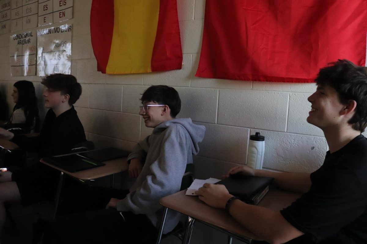 Paying attention to the screen, sophomores Aj Creguer, Gerard Gilmore, and Easton Willingham enjoy their classmates' presentation. On Mar. 5, Spanish Teacher Hillary Fischer's  class made videos in Spanish for others to watch. 