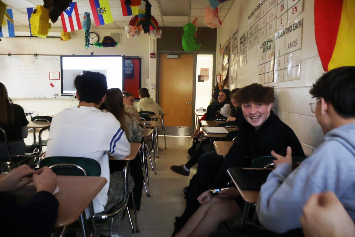 Laughing, sophomore Easton Willingham reacts to his classmates spanish project videos. On Mar. 5, the spanish class watched each others videos about chores.