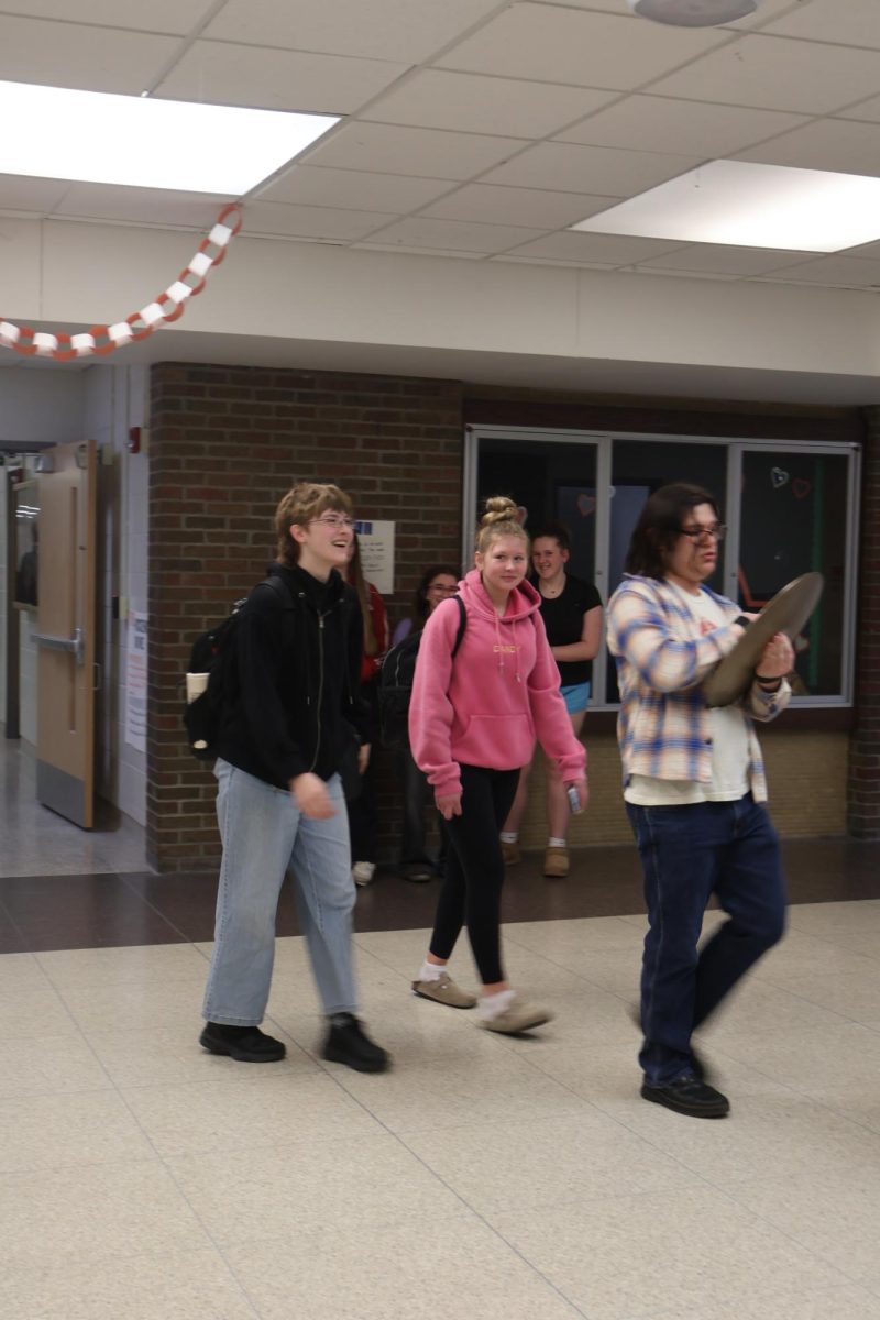 Walking out, junior Madison Rush and sophomore Mia Salvia have a clap out for figure skating. On March 20, they head to the states for figure skating.
