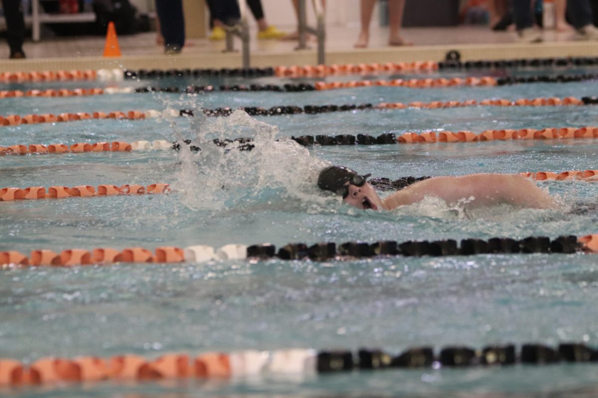 Swimming the freestyle, junior Drew Miner races the freestyle. On Feb. 27, the Fenton boys Swim and Dive team held metros at home.