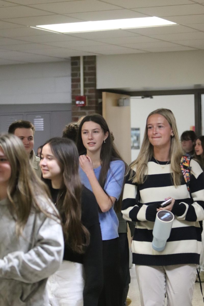 Strolling the halls, senior Addison Smith and junior Maryn Teddy walk the hallway for their clap out. On March. 5, the DECA had a clap out for going to states.