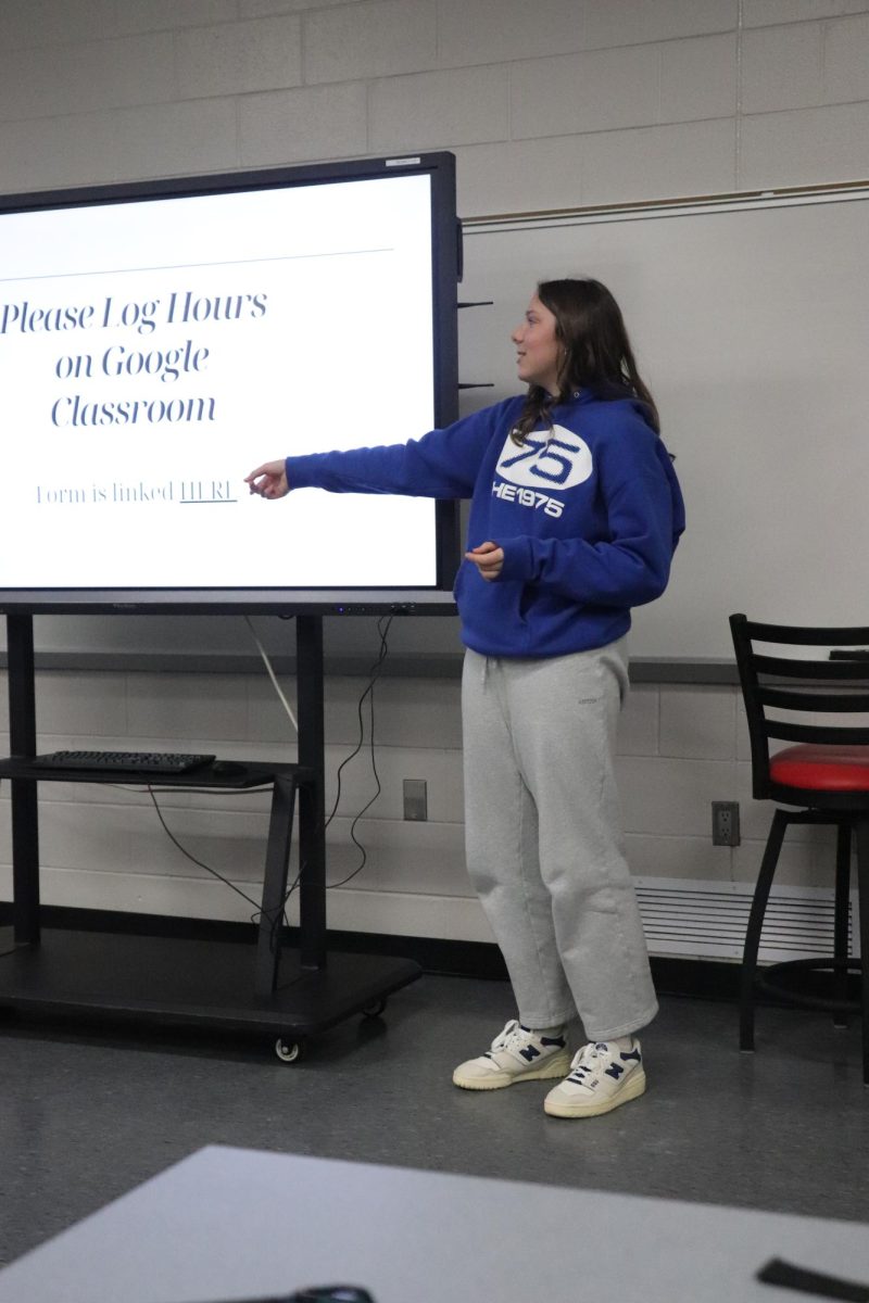 Talking to the crowd, senior Grace Perry goes over Key Club elections. On March 19, Key Club had a meeting about next year's staff. 
