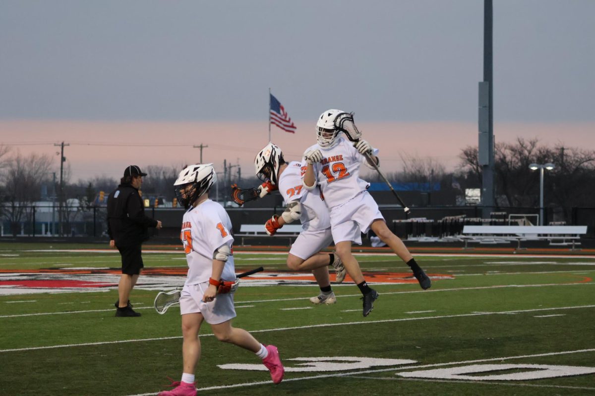 Jumping into each other, junior Jeremy Moore and Aiden McKenna celebrate their score as they get another point. On March 20, Fenton goes against Swartz Creek/Flushing and wins 8-7.