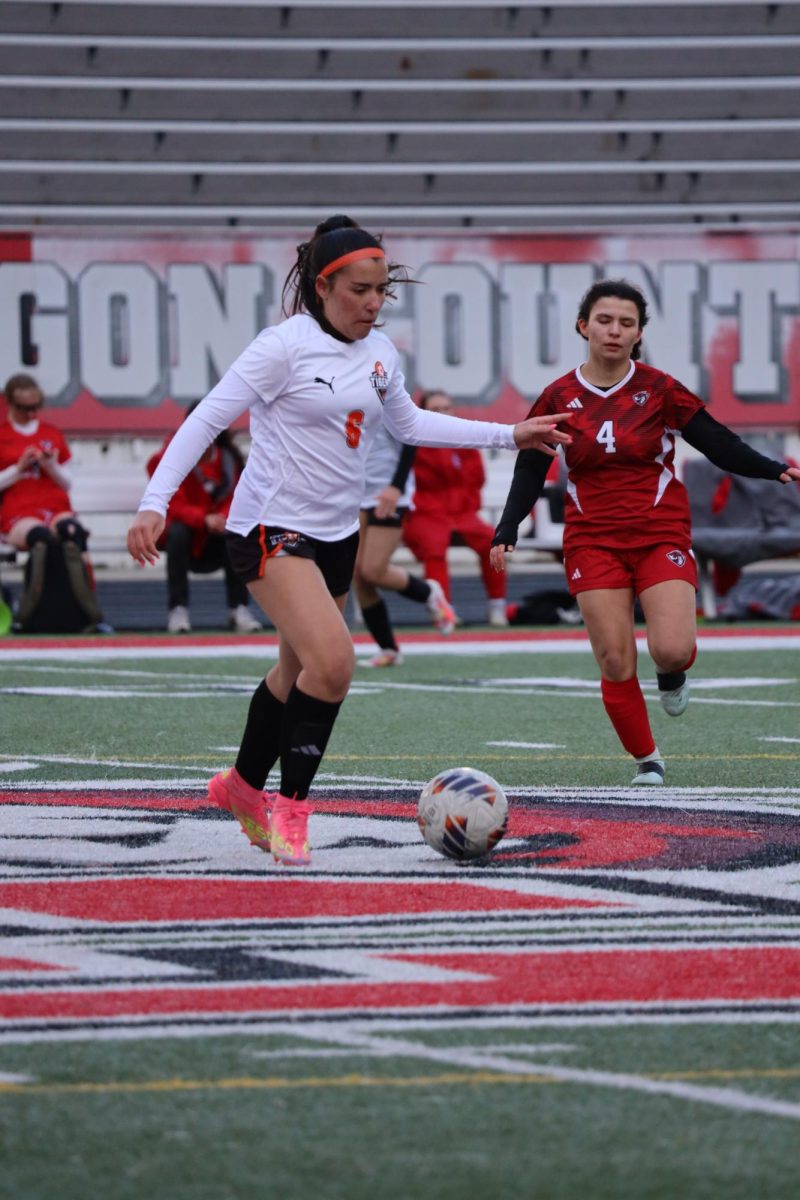 Preparing to kick the ball, senior Sophie katsef plays offense. On April 6, the girls varsity soccer team played swartz creek and won 2-0. 

