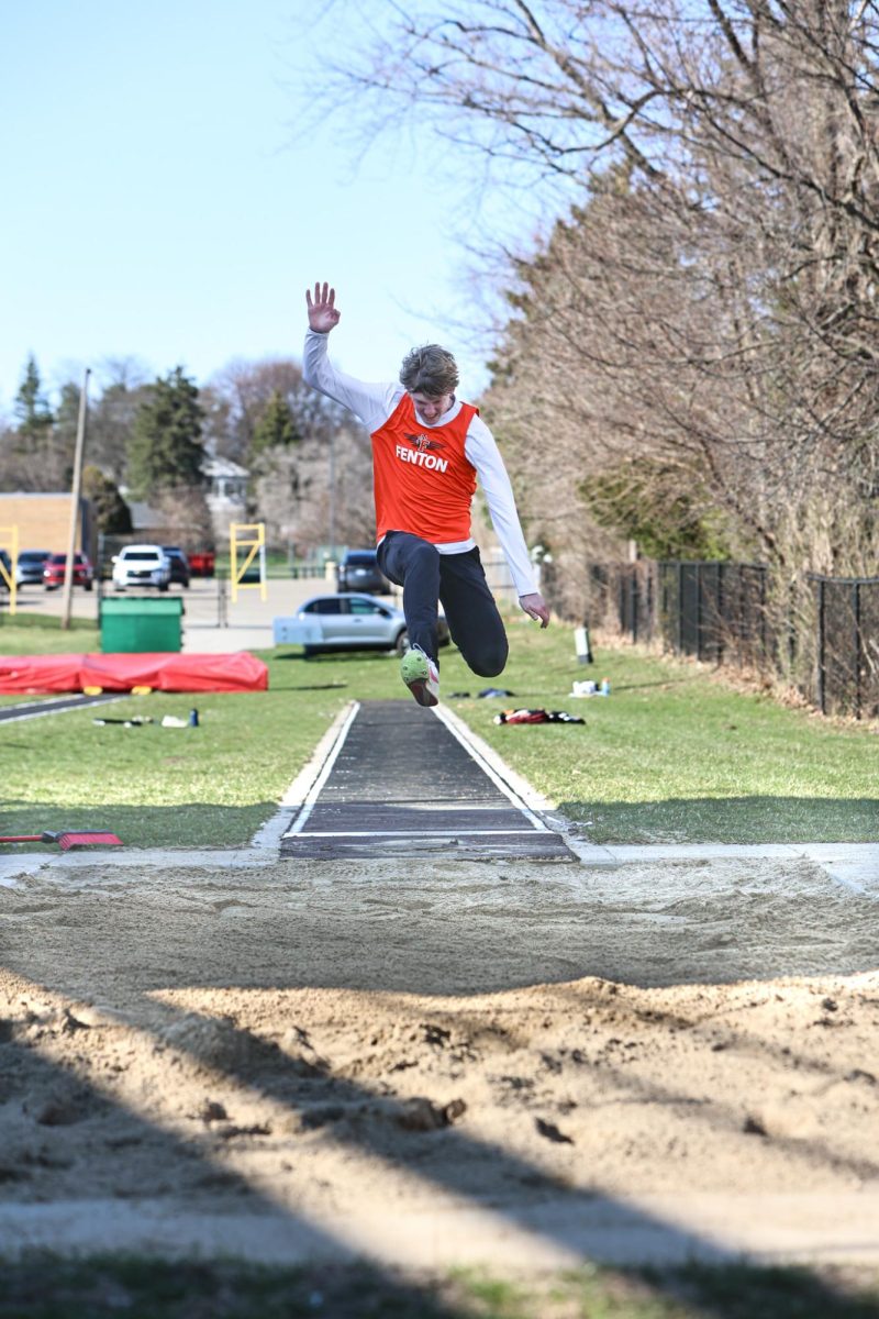 Competing in the long jump, junior Jackson Martin participates in his event. On Apr. 7, the Fenton Track team had a meet in Swartz Creek and won. (find score later).