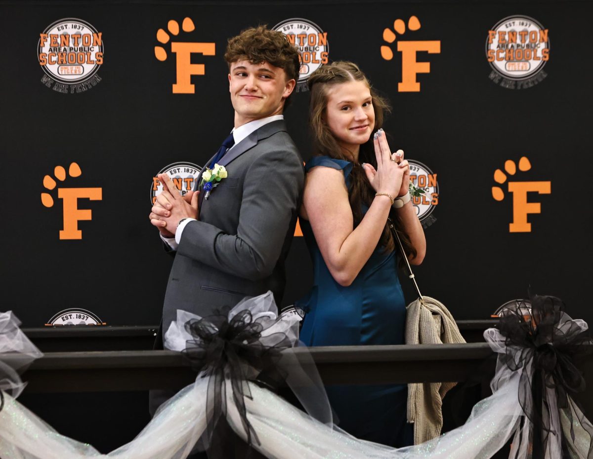 Posing for pictures, senior Noah Short and Alexis Stone walk out on the red carpet. On April 18, Fenton held a red carpet walkout for prom.