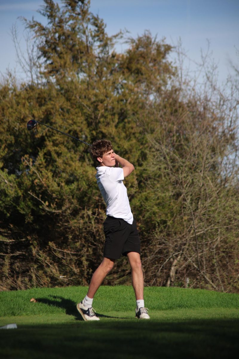 Looking at the horizon, junior Lewis Roberts tees off. On April 17, the boys' varsity golf team won with a score of 173 to Swartz Creek's 197.
