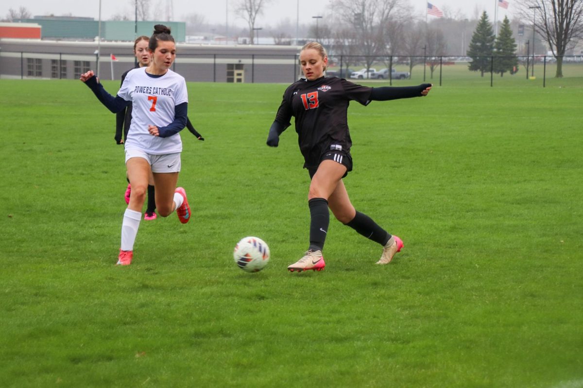 Preparing to kick the ball, freshman Wesley Foguthe plays in a collaborative game with her team. On April 10, the girls JV soccer team played Powers and won 4-0 
