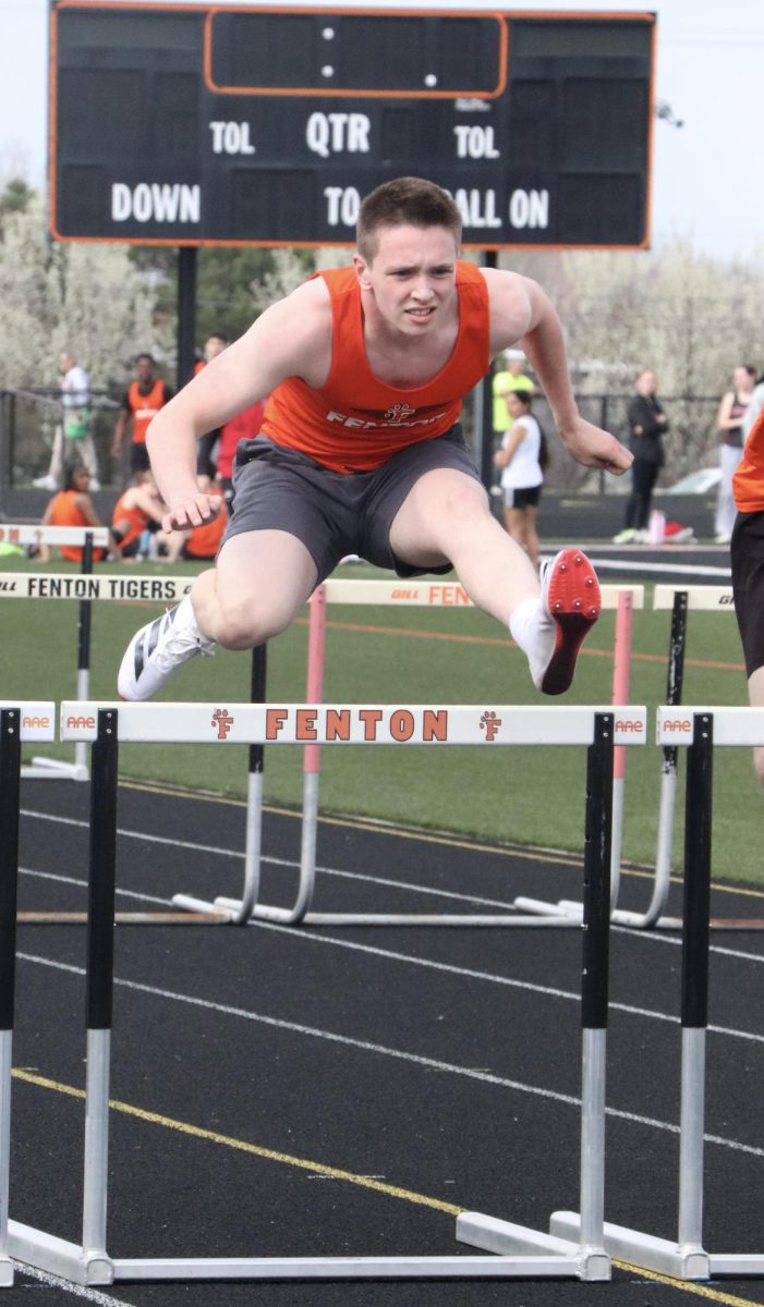 Jumping over the hurdles, senior Michael Ferris competes in the 110 meter hurdles. On April 21, the Fenton boys' track team lose to Linden. 