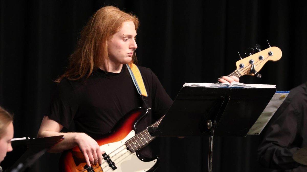 Playing bass, senior Ash Holmes performs in front of an audience. On April 15, FHS held its annual spring band concert in the auditorium.
