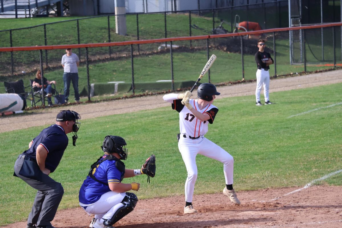 Setting himself up, Sophomore Brandon Perantoni gets ready to hit the ball. On April 13, Fenton JV black baseball goes against Kersley. 