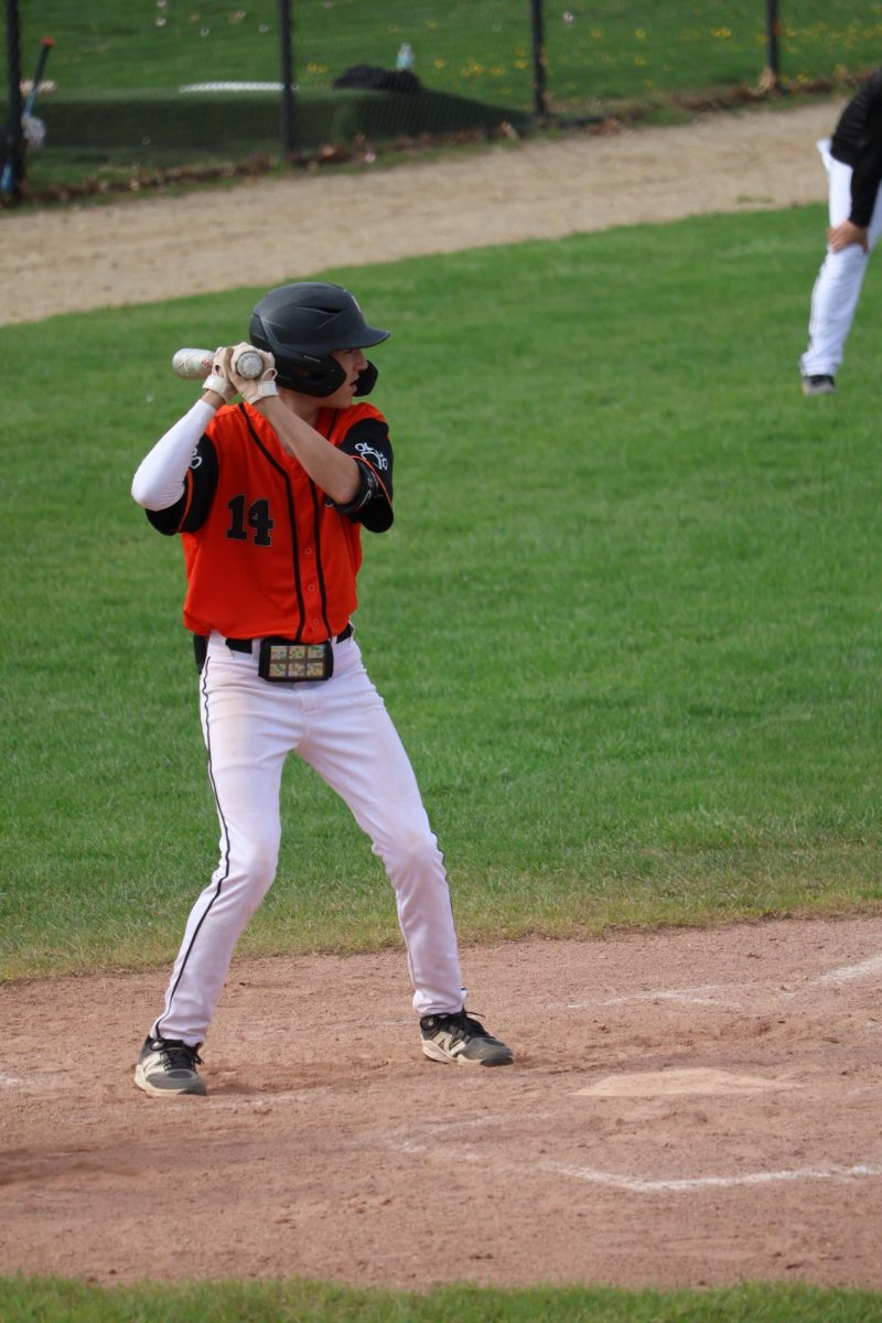 Anticipating the pitch, Freshman Jack Kopcyzk waits to hit the ball. On April 21, the Fenton JV orange baseball team beat Flushing 5-3.