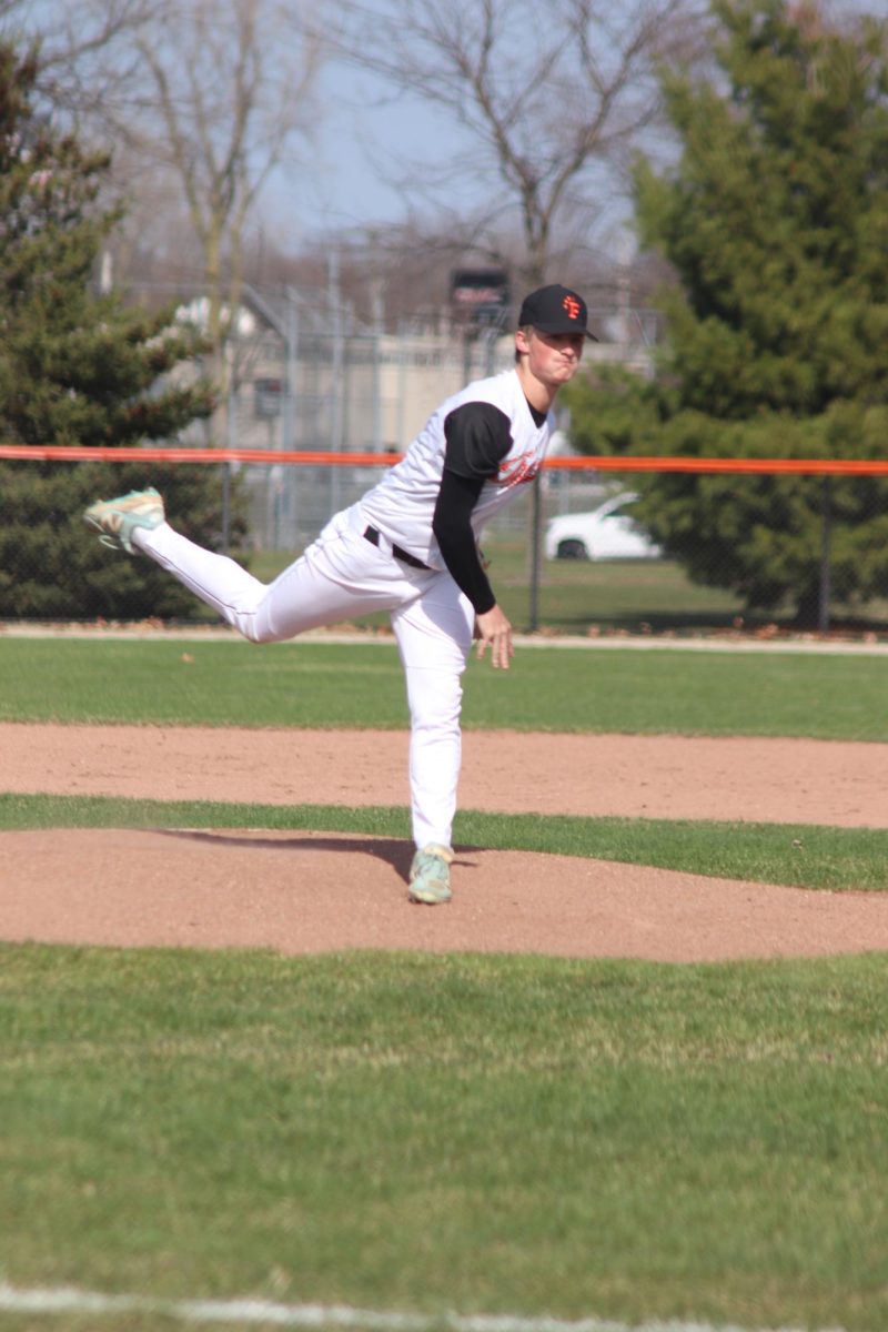 Pitching on the mound, senior Noah Sheil throws the ball. On April 8, Fenton Varsity played Lake Orion High School and won 6-3.