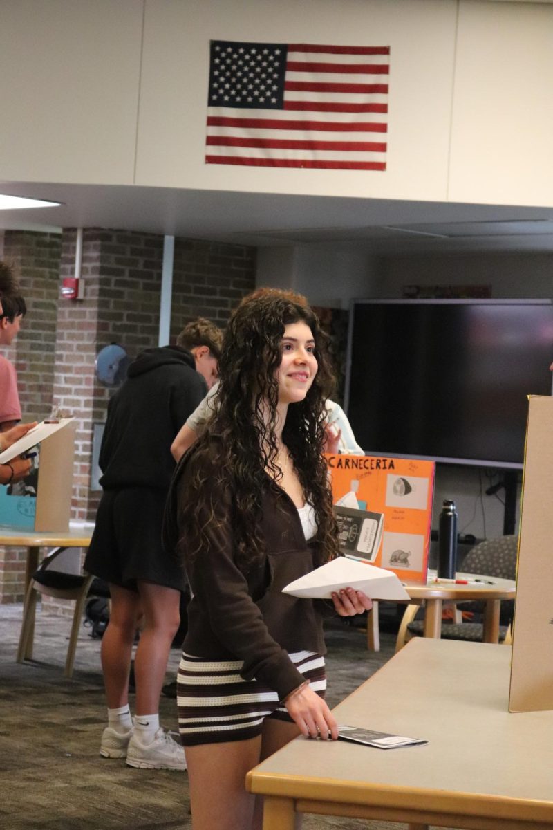 Bargaining for a price, freshman 
Isabella Aimar shops in the market. On May 18, the Spanish classes create a Spanish market for Spanish 2 and 3 to participate in. 
