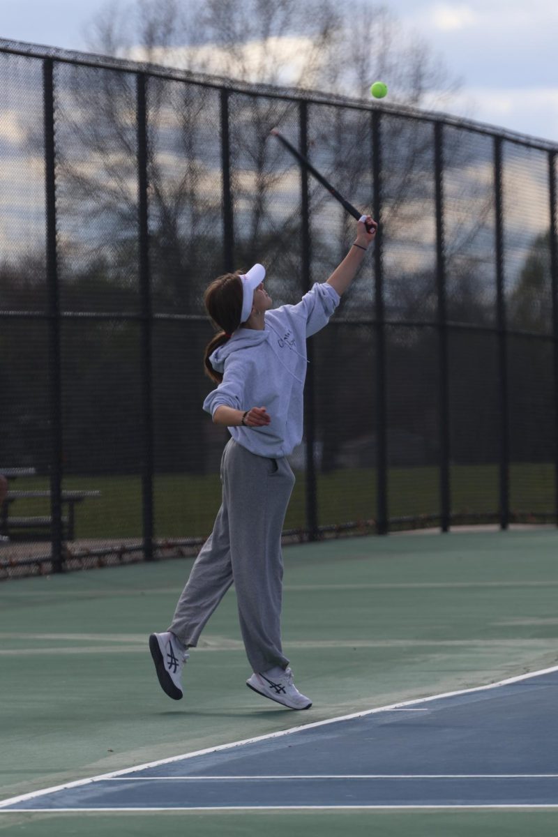 Looking, sophomore Grace Wolner aims to hit the ball. On April 30. the FHS girls tennis team went up against Goodrich High School.