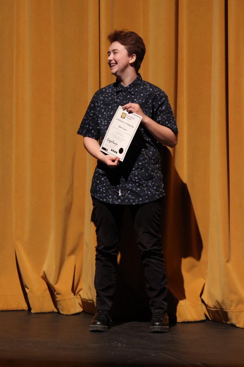 Posing, junior Elliot Green wins an award. On April 30. FHS held its first drama banquet.