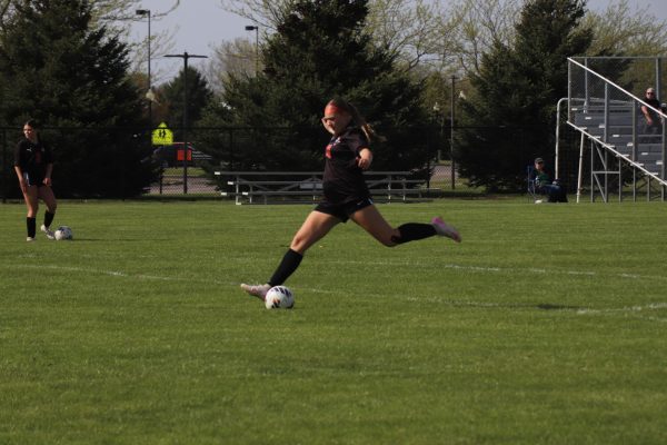 Raising her leg to kick the ball, Freshman Paislee Will plays in a high-stakes game with her team. On May 5, the girls JV soccer team plays Goodrich and loses (finding score) 
