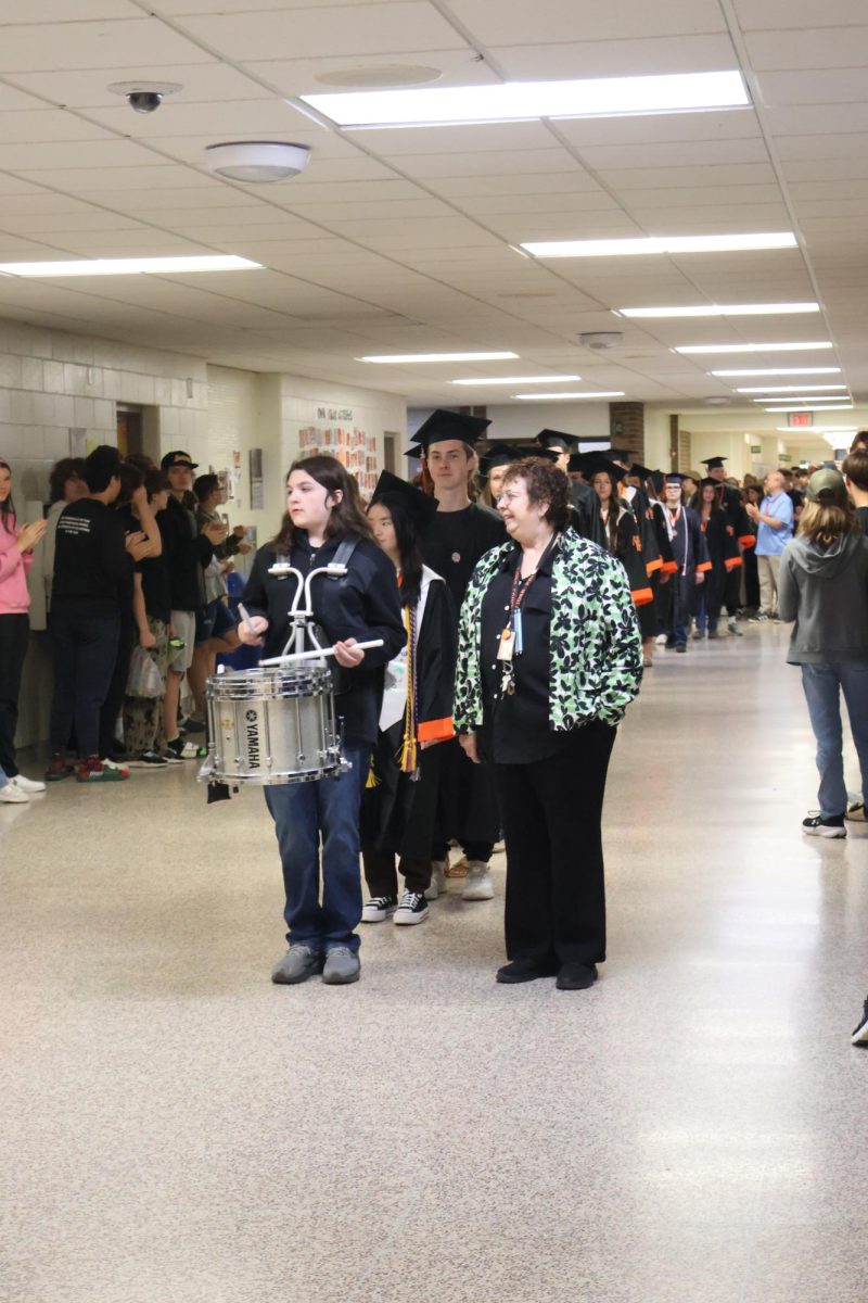 Leading the line, Conor Jernigan guides the seniors through Fenton High School for their clap-out. On May 14, Fenton High School celebrated the graduating seniors by applauding them while they walked by.