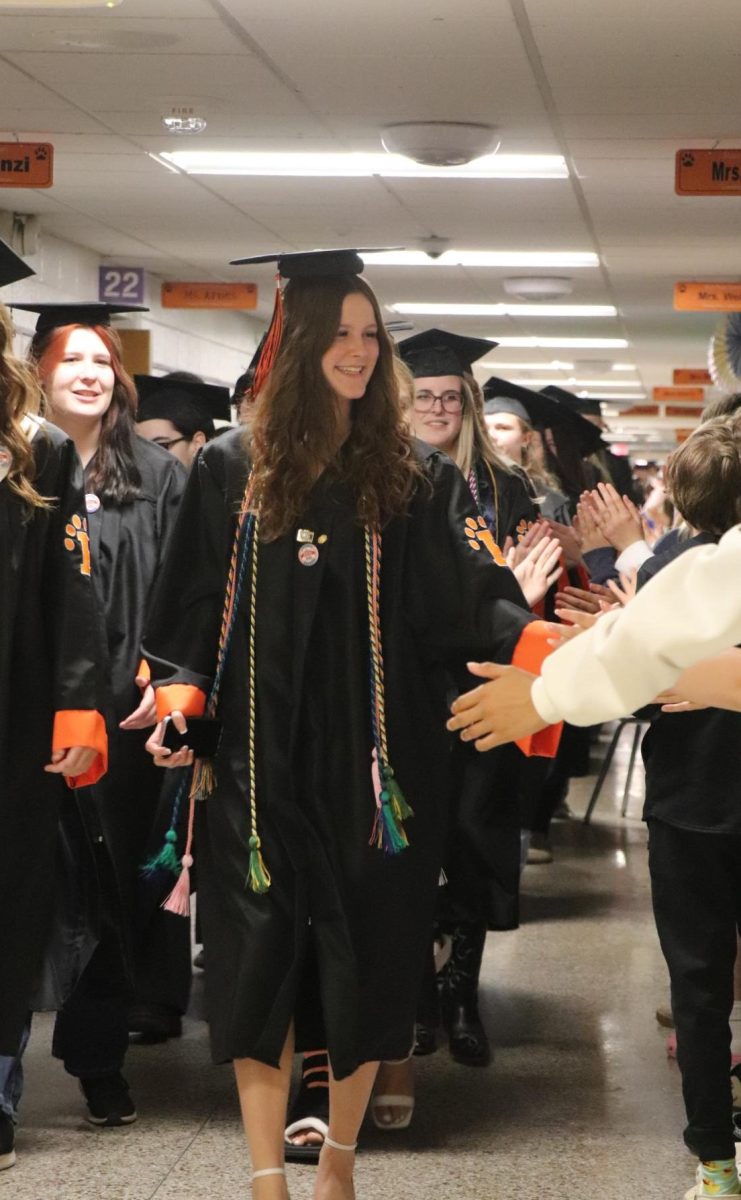 High-fiving the elementary kids, Senior Haven Selby does her last walk through of her old elementary school. On May 15, the senior class celebrates their graduation by walking through their old elementary schools. 