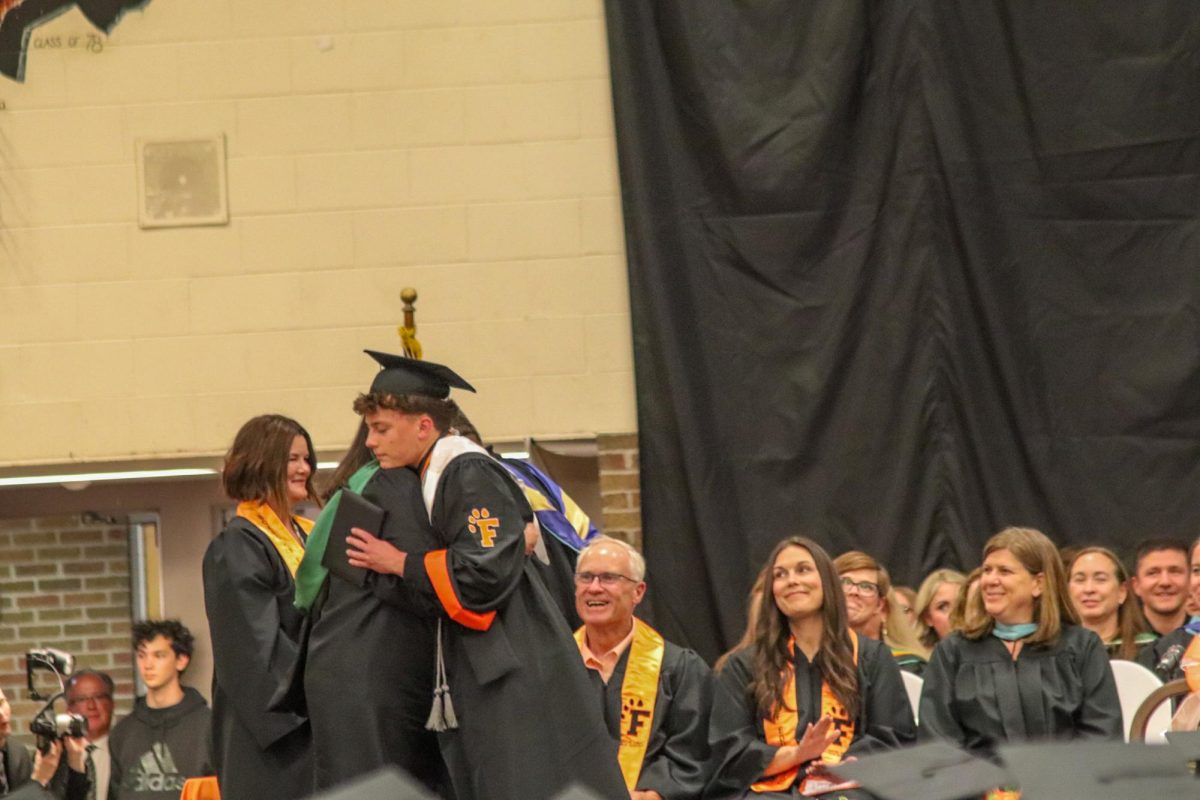 Hugging his mom, senior Graham Groves receives his High School Diploma. On May 15, FHS held the Graduation of the class of 2026 in the gymnasium. 