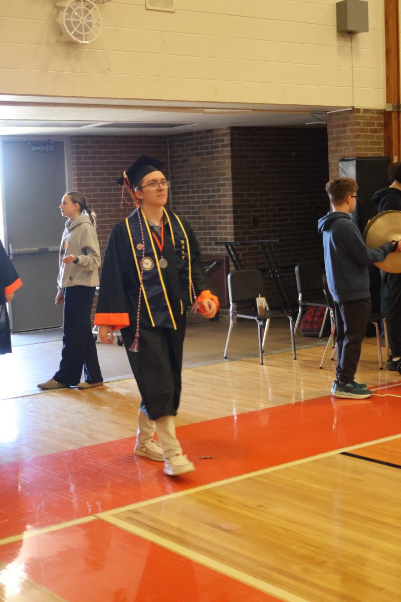 Walking towards his seat, Senior Chris Lad prepares to be commemorated. 
On May 14, the seniors participated in an honorary graduation ceremony hosted at the school. 
