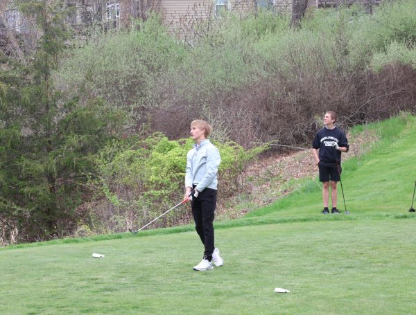 Watching the ball fly, freshman Weston Temrowksi reacts to his drive. On May 5, the JV golf team faced Goodrich, with the Tigers winning 195 to 197.