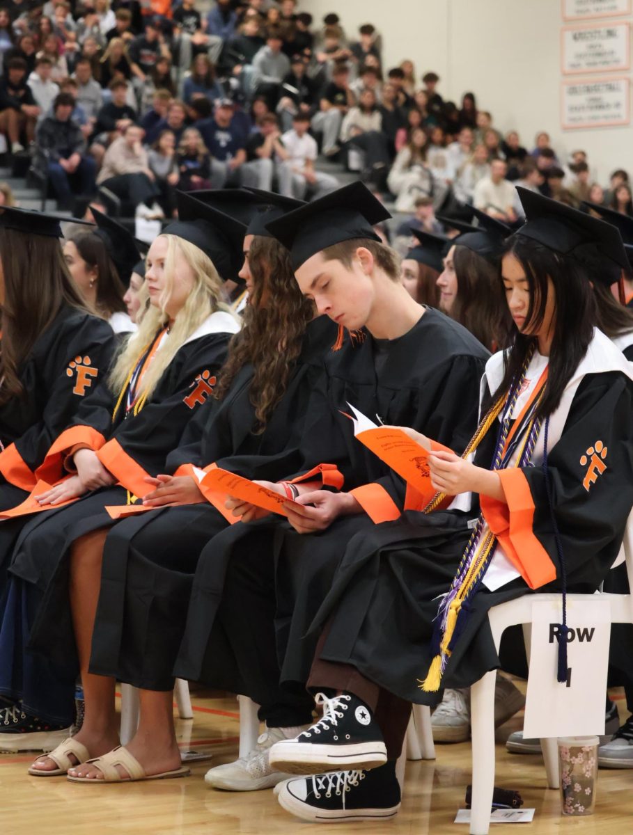 looking at the pamphlet, senior Anthony Malnati reads the program. On may 14 fenton high school held a honers assembly for a graduating class. 